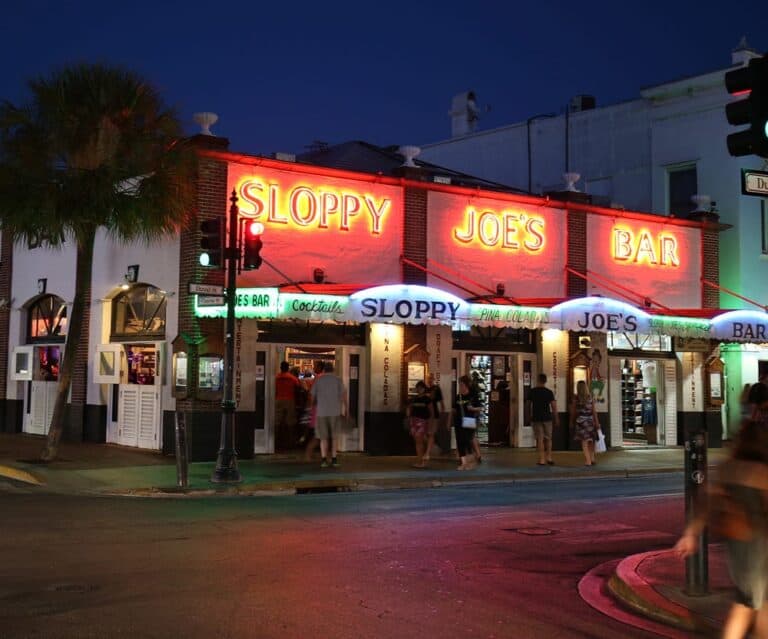 Sloppy Joe's Bar illuminated at night in Key West, popular for drinks and nightlife.