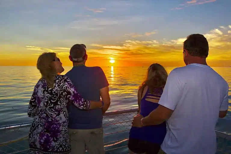 Sunny sunset over the ocean with friends enjoying a sunset sailboat cruise in Key West.