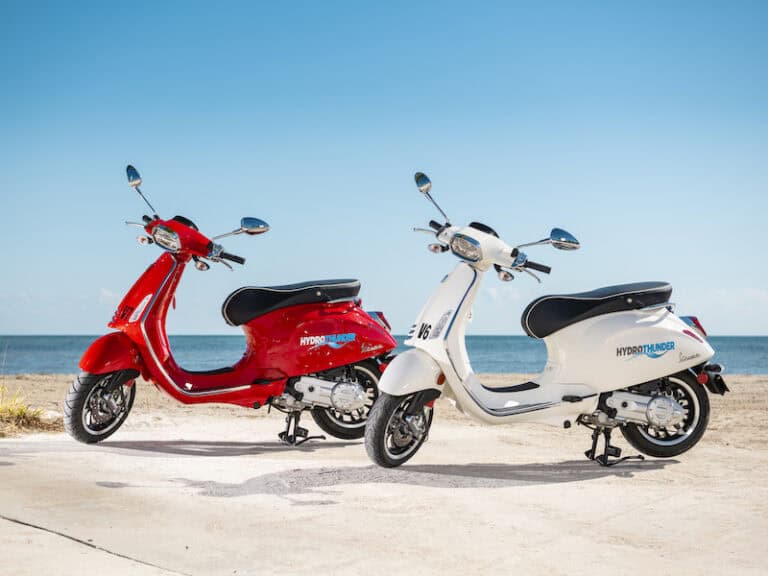 Red and white scooter rentals on the beach in Key West, offering convenient transportation options.